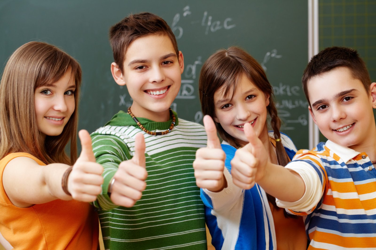 Classmates Portrait of happy teens showing thumbs up
